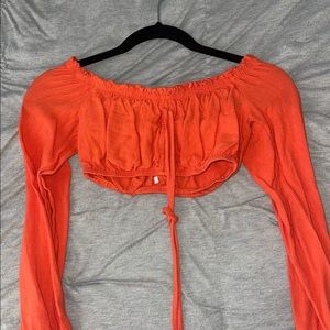 Orange off the shoulder crop top.